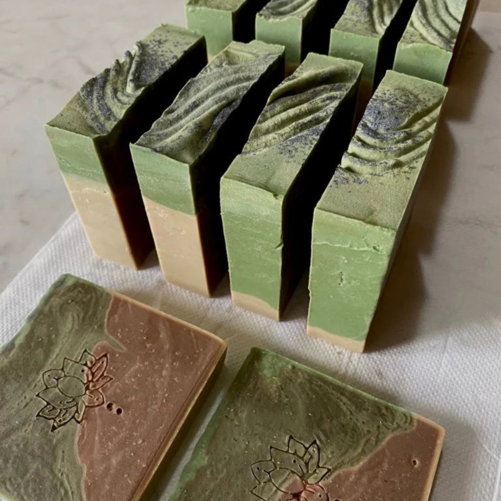 Freshly cut botanical soap bars resting on a linen cloth